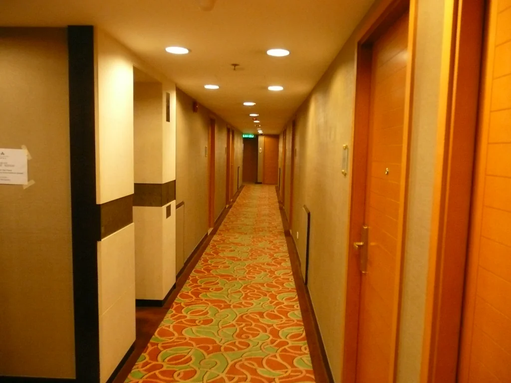 A hotel corridor with guest room doors
